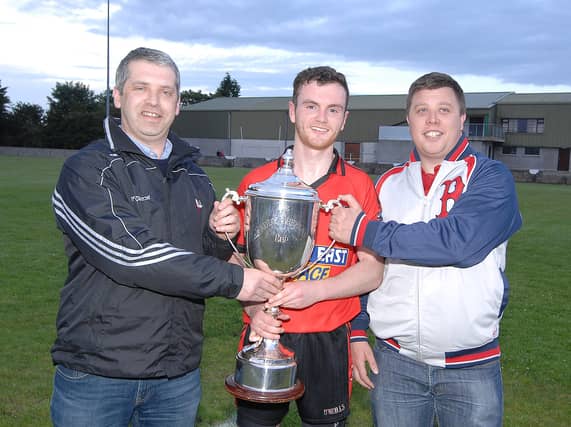 Mattock captain Michael McKeown being presented with the Paddy Sheelan Cup by Des Halpenny (Louth County Board chairman) and Darren McCann (Sheelan family) Pic: Arthur Kinahan)