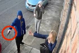The man holding what appears to be a gun at the scene of the incident
