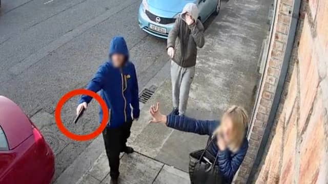 The man holding what appears to be a gun at the scene of the incident