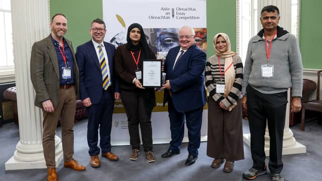 Fatima Memon collected her prize with teacher, James Shovlin, Senator Rónán Mullen, Iar‑Cheann Comhairle Seán Ó Fearghaíl, and parents Zaibunnissa and Fayaz Memon