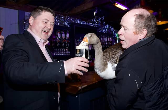 Concepta slugs a pint of Guinness at the parade presentation night in Tullamore with owner John Dolan and Cllr Shane Murray
