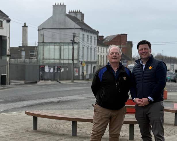 Deputy John Clendennen and Cllr Noel Cribbin with the site of the new Edenderry library in the background
