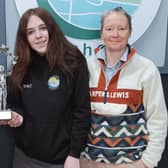 Winning student Niamhín Kearney is presented with her award by Seamus McLaughlin, of the Buncrana Tidy Towns Initiative. Also pictured is Coláiste Eoghain teacher Donna Marie McFaul.