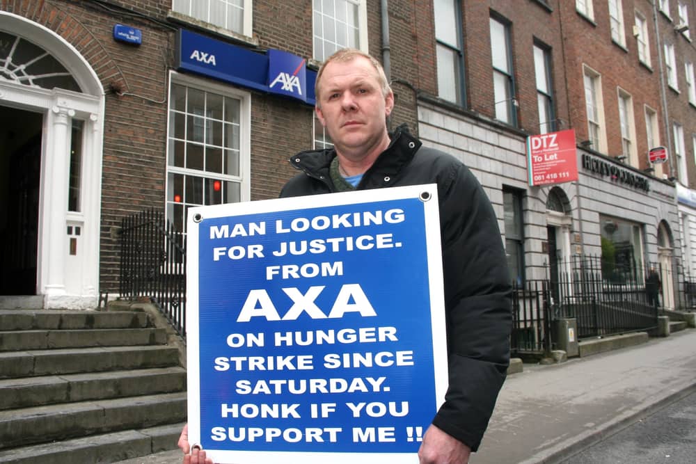 Gerry McDonagh protesting outside Axa insurance on O'Connell Street Picture: Adrian Butler