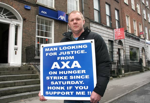Gerry McDonagh protesting outside Axa insurance on O'Connell Street Picture: Adrian Butler
