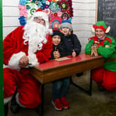 Santa and his elf meets children at Butler House