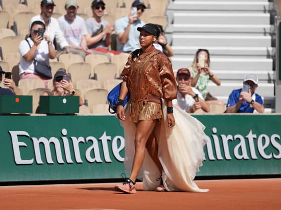 Naomi Osaka walks onto court