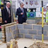 Sir Keir Starmer and Pat McFadden meet an apprentice working to build a wall