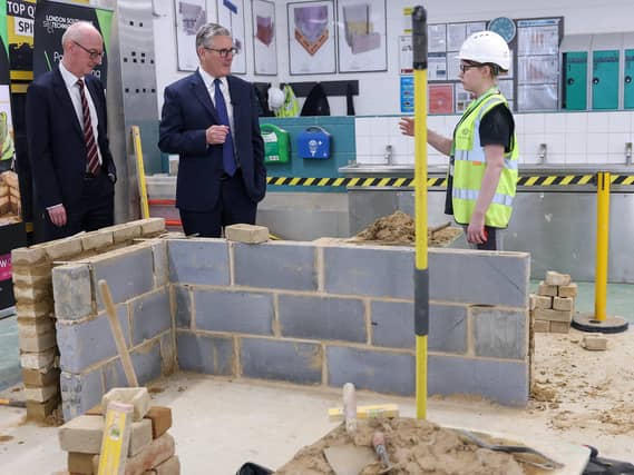 Sir Keir Starmer and Pat McFadden meet an apprentice working to build a wall