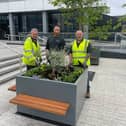 Council staff pose with the planters following their installation