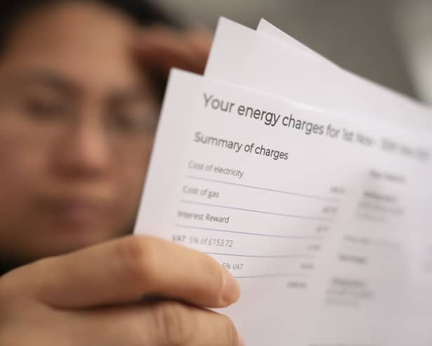 A woman looking at a fuel bill