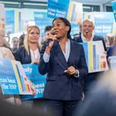 Kemi Badenoch speaking to a crowd using a microphone