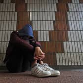 Teenager with head on knees