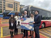 Stephen Flynn and a group of young people holding a big NEC card