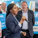 Kemi Badenoch speaking into a mic, as Douglas Lumsden looks on, in front of Tory supporters