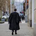 A barrister outside the Crown Court at Laganside in Belfast as the start of a month long withdrawal of services in legal aid funded cases in the crown court in an ongoing dispute over fees
