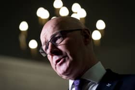 John Swinney with lights around his head