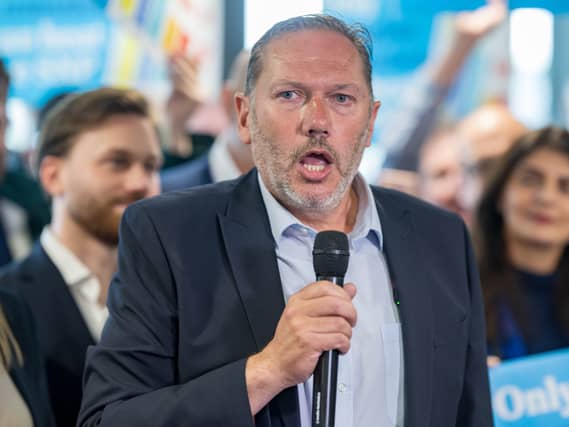 Aberdeen South MP Douglas Lumsden speaking into a microphone