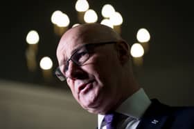 John Swinney cocking his head to one side as he speaks