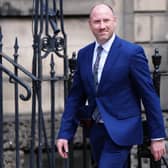 Neil Gray walks along the street