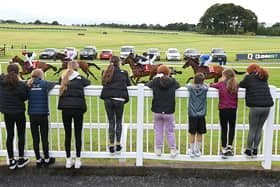 Young racegoers watching the runners race past at the County Mayo venue.