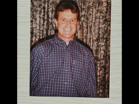 A family photo of John Gillies smiling