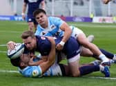 Rory Hutchinson, centre, scores a try