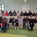 Donegal Half Marathon Committee members pictured with staff and pupils during a visit to Little Angels Special School.