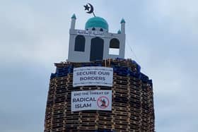 A bonfire pyre with a replica mosque on the top