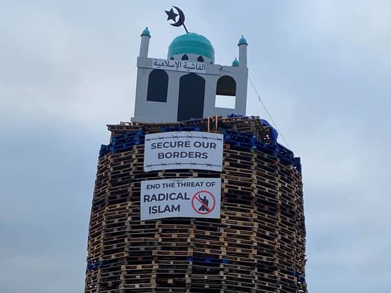 A bonfire pyre with a replica mosque on the top