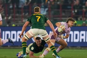Scotland’s Kyle Rowe, right, is tackled by South Africa’s Cobus Wiese
