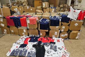 Boxes with counterfeit football shirts on top