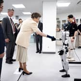 The Princess Royal shakes the hand of a robot during a visit to the Jung Woonoh IT & General Education Centre on the on the Seoul campus of Korea University