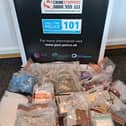 suspected Class A and Class B drugs were seized along with cash and drug-related paraphernalia.