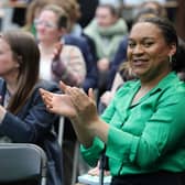 Iris Duane clapping and smiling while in an audience