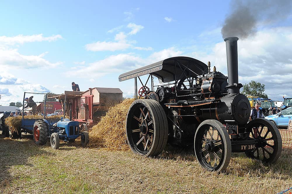 Old style threshing with a 1912 Fowler B8  steam engine at a previous Knockbridge Vintage Rally