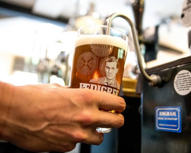 Person pulling a pint