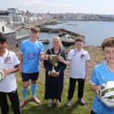 The Mayor of Causeway Coast and Glens Borough Council, Councillor Dawn Huggins, is pictured with Rohan Roy and Ronan O'Donnell from Maiden City, and Levi Weir and Archie Muir from Ballymena United, who will compete in the Minor Section of the 2026 Budget Energy SuperCupNI.