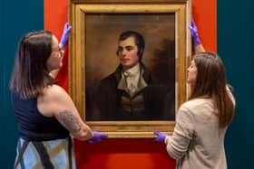 Robert Burns portrait being put on wall