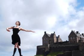 A dancer performing in front of Edinburgh Castle