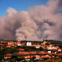 Smoke from a wildfire near homes in Spain