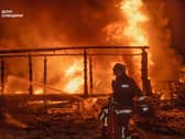 Firefighters put out a fire following a Russian air attack in Sumy