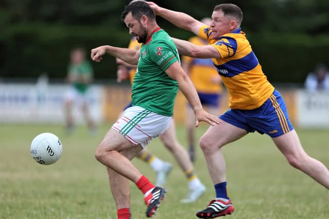 Colmcille match winner Barry McKeon attempts to get his shot off despite the close attention of Carrickedmond defender Dermot Brady during Friday's Peter Hanley Motors Longford Senior Football Championship Group B - Round 2 contest in Emmet Park, Killoe.