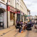 Customers outside a Merrie England cafe