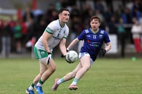 Killoe Emmet Óg's Ronan Keogh prepares to give a handpass as Rathcline's Oran Kenny attempts to close him down during Saturday's Peter Hanley Motors Longford Senior Football Championship encounter in Ballymahon 