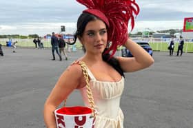 Limerick influencer Chloe Koyce  pictured showcasing a bespoke KFC-inspired fascinator and matching bucket bag, designed by Irish designer Maya Grisham at the Galway Races
PICTURE: Galway Races