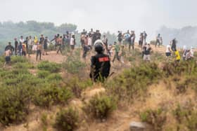 A member of the Moroccan security forces stands guard as people attempt to cross to the Spanish enclave of Ceuta