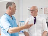 John Swinney speaks to an NHS worker
