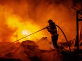Firefighters put out a fire after Russian missiles hit a warehouse in Kyiv, Ukraine