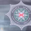 PSNI badge in police car window